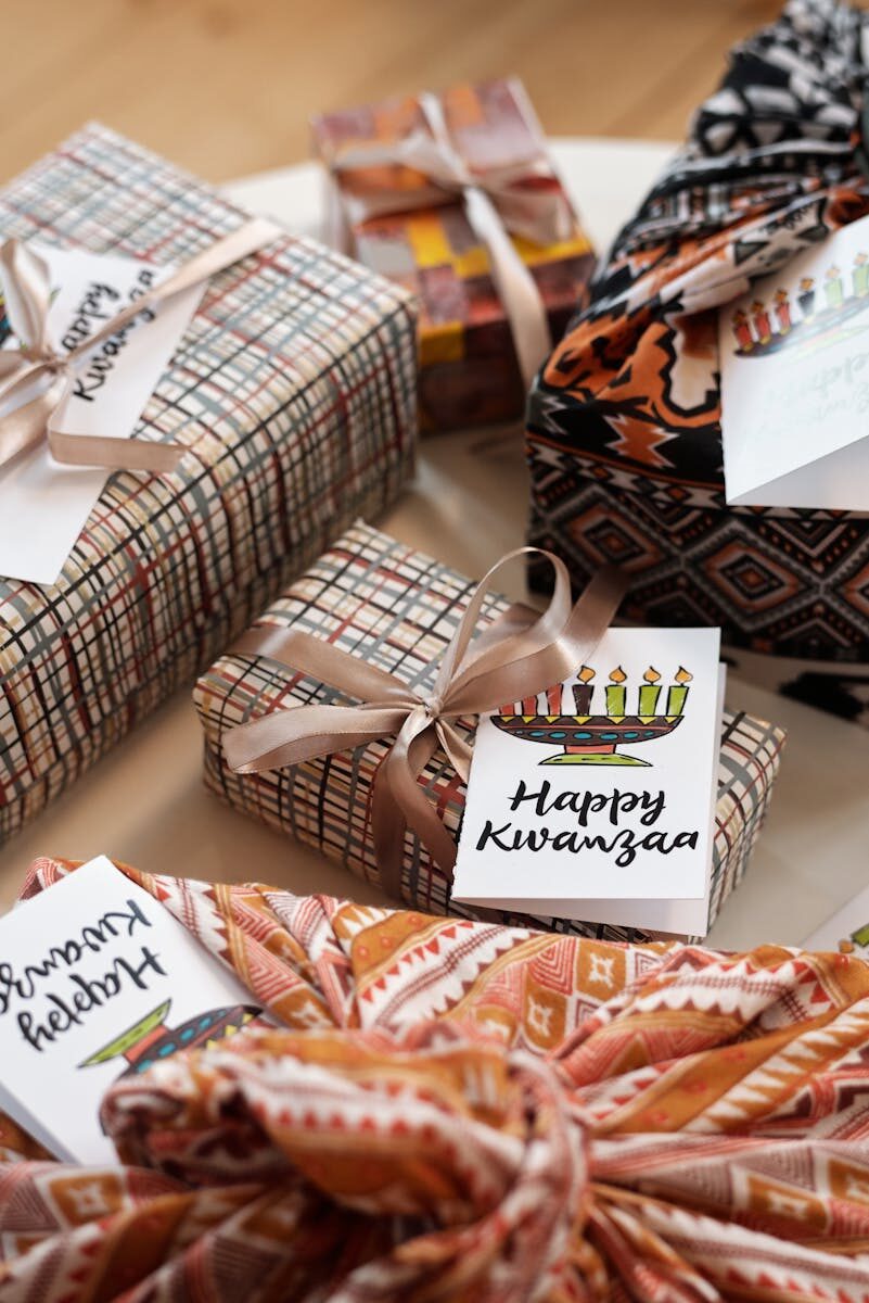 Beautifully wrapped Kwanzaa gifts with traditional designs and Happy Kwanzaa cards.